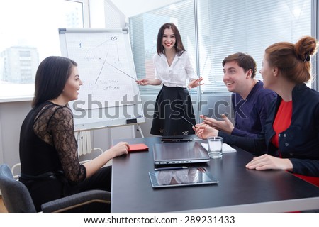 a group of businessmen in a meeting looking at the board