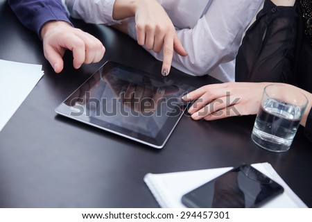 hand a group of businessmen on a table with a tablet, mobile phone