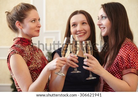 beautiful girls at a Christmas party with glasses of champagne