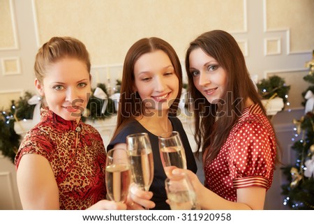 three beautiful girls on New Year's party with champagne