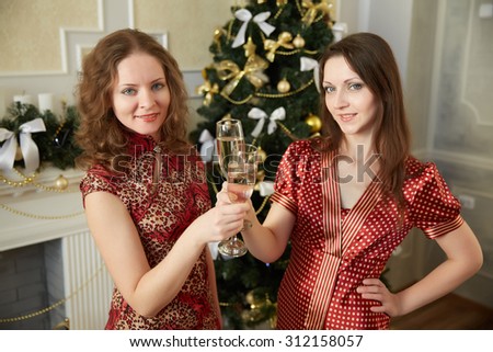 two beautiful girls on New Year\'s party with champagne