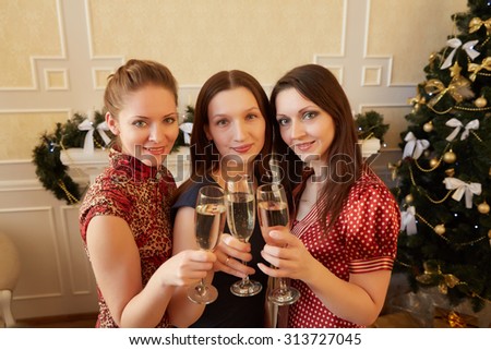 three beautiful girls on New Year\'s party with champagne