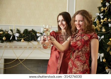 two beautiful girls on New Year\'s party with champagne