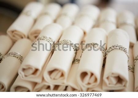 many curled napkins with rings in a restaurant