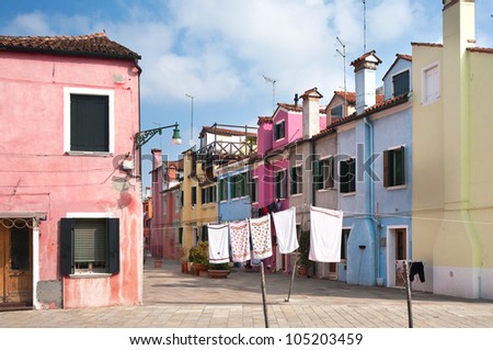 Venice, Burano island street with small colored houses, wash laundry