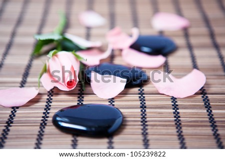massage stones and flower, like a concept for wellness, body care and yoga symbols