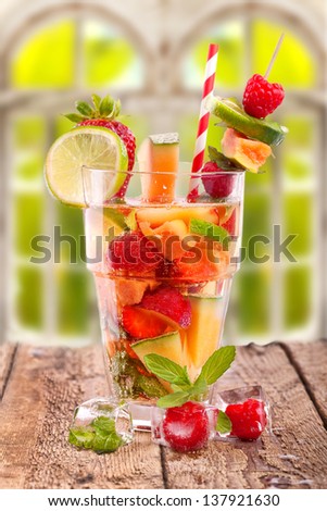 fresh fruit drink on rustic wooden  table in summer and spring with natural Background outside the window