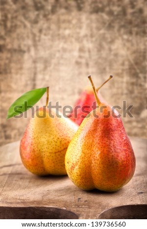 Fresh juicy pears on wooden table on rustic background