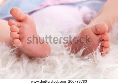 Small little feet of newborn baby