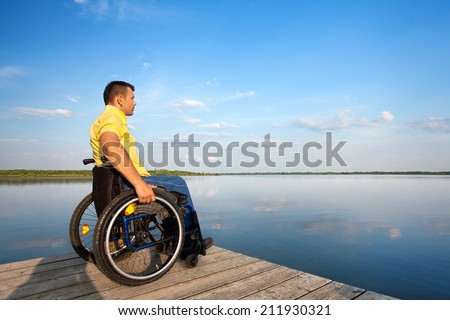 wheelchair user looks into the distance, enjoy summer on the lake