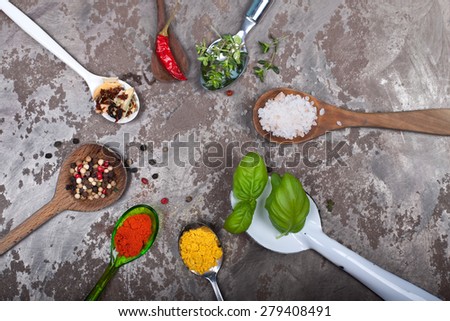 sharp round - herbs and spices on several spoons on a sheet background
