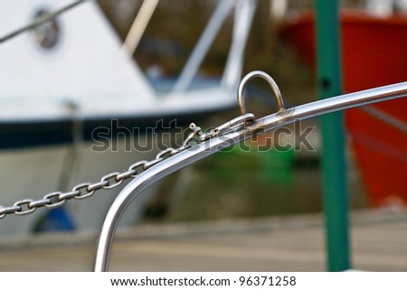 silver heavy chain attached to metal bar via a metal clasp
