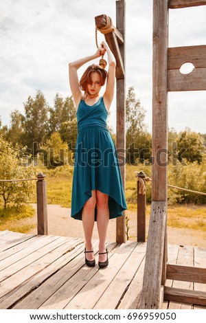 https://image.shutterstock.com/display_pic_with_logo/99006/696959050/stock-photo-young-beautiful-women-posing-on-gallows-696959050.jpg