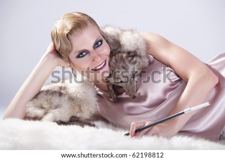 Happy Lady posing with a fox fur with a cigarette in studio