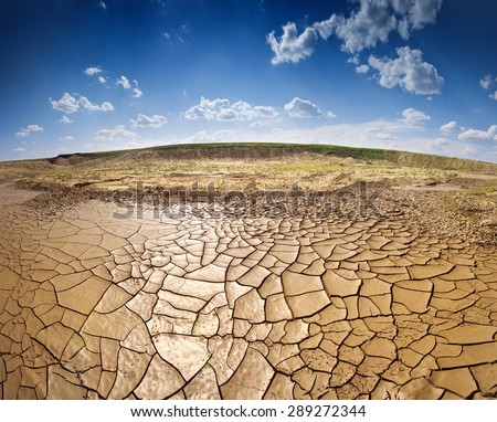 Dry lake under blue sky with clouds