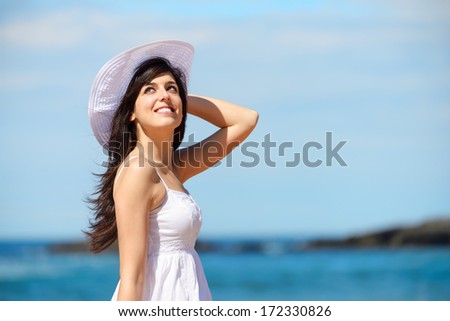 Woman on beach summer vacation. Relaxed girl enjoying summertime leisure and recreational walk.