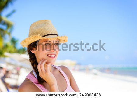 Relaxed charming woman enjoying tropical caribbean vacation at the beach in Playa del Carmen, Riviera Maya, Mexico. Caucasian brunette on vacations looking to side for copy space.