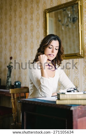 Woman reading or studying at home on vintage desk and workplace.