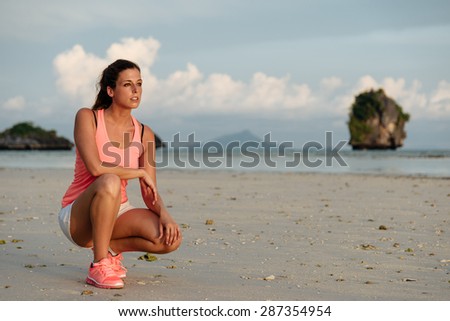 Woman ready for running and exercising at beach on summer, Krabi, Thailand. Female athlete training outdoor.