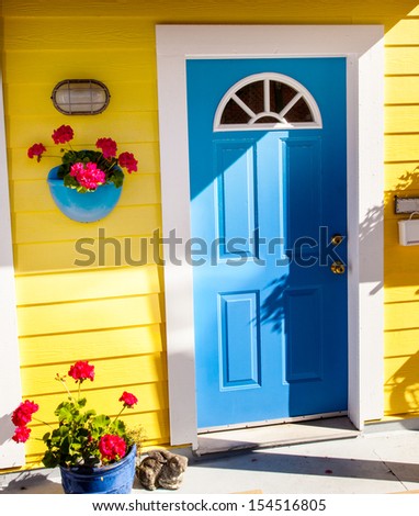 Floating Home Village Yellow Blue Door Brown Door Houseboat Fisherman\'s Wharf Inner Harbor, Victoria British Columbia Canada Pacific Northwest.  Area has floating homes, piers, and restaurants.