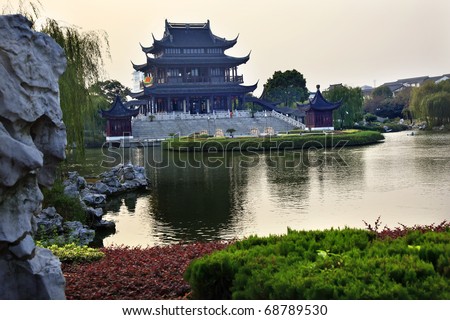 Ancient Chinese Hall of Four Auspicious Merits and Hall of Attractive Scenery Pan Men Scenic Ares  Suzhou, Jiangsu, China Garden Lake Reflection Flag is not a trademark.  It says tea in Chinese.