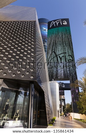 LAS VEGAS - APRIL 19: Aria hotel sign on April 19, 2013  in Las Vegas. Tourists are dwarfed by the new Aria Hotel sign which is 250 feet tall and 65 feet wide,