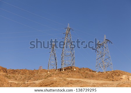 Large power Towers perched on the top of a mountain carry electricity away from Hoover Dam in Nevada.