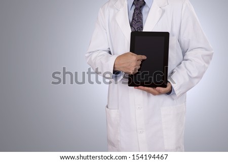 A Physician gives a demonstration with his tablet computer. Negative space on left side for copy.