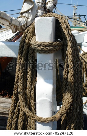 Nautical ropes hanged on a classical wooden sail boat yacht