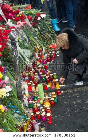 KIEV, UKRAINE - 23 February 2014: Citizens of Ukraine came in a day of mourning for the dead in the confrontation with the security forces, lay flowers and light candles