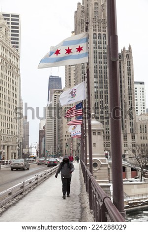 CHICAGO - FEBRUARY 4: Pedestrians crossing the Chicago River Bridge in winter on February 4, 2014 in Chicago, IL.The winter of 2014 will be recorded as one of the harshest winters in the midwest.