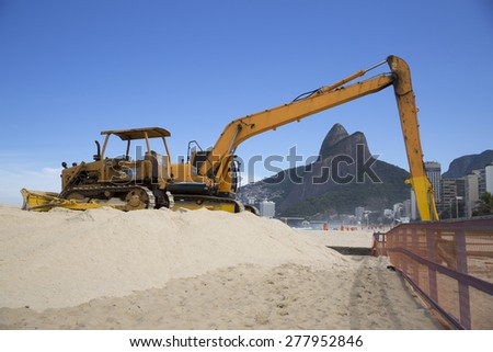 RIO DE JANEIRO/BRAZIL - MAY 11 2015: Excavator works on Ipanema Beach in Rio de Janeriro on May 11, 2015. Ipanema is one of the most famous touristic beaches in Brazil.