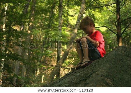 A Little Boy Sitting On A Big Rock Pouting. Stock Photo 519128 ...