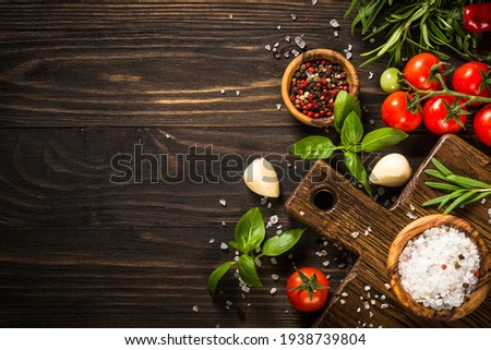 Similar – Image, Stock Photo Food background with cutting board and various healthy flavor seasoning ingredients: herbs, garlic, olive oil, chili powder and pepper. Cooking at home with flavorful spice. Top view. Border