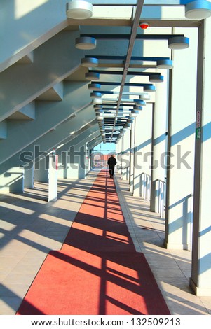 Man walks down the hall in sports center/corridors of life