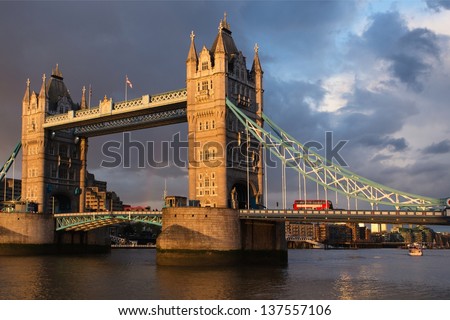 London tower bridge at dusk with double decker bus crossing