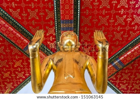 Gilded Buddha statue view from above with diminishing perspective in Wat Pho temple in Bangkok, Thailand