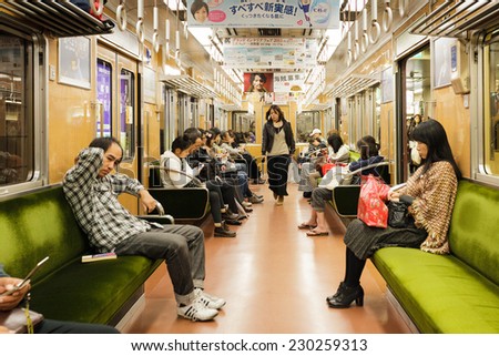 OSAKA, JAPAN, NOVEMBER 15, 2011: People are sitting after work inside a modern and clean train of the Japanese subway in Osaka, Japan.
