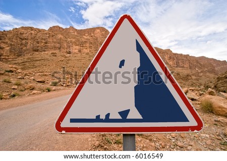 danger falling stone sign on desert road