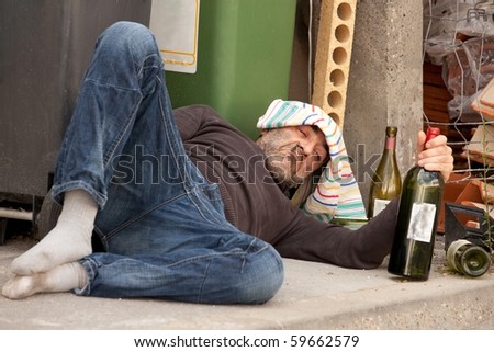 Poor And Drunk Man Lying On Sidewalk With Bottles Of Wine Near Trash ...