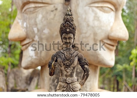 buddhist statue standing over double headed buddha face, nong khai, thailand