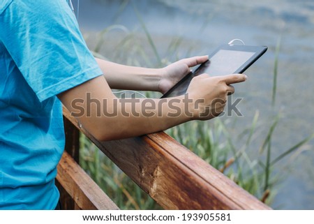 Lifestyle Tablet Tech User Enjoying Vacation with retro filtered color effect