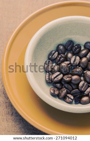 Coffee beans for espresso shot in a cafe or coffee shop. Photo in vintage color tone style.