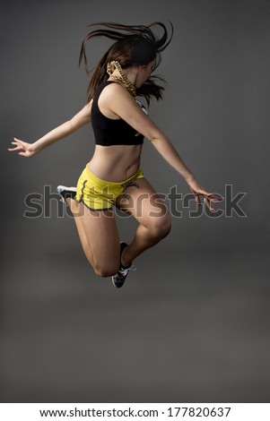 Fitness active girl jump over grunge background