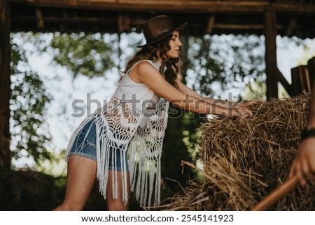 Similar – Image, Stock Photo Woman Pushing Hay Bale