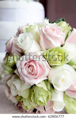 A wedding bouquet of pink and green roses.