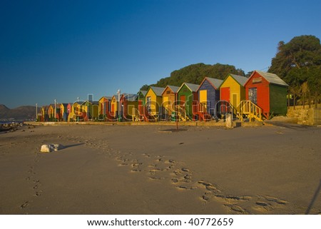 A row of brightly colored beach huts. Taken at St James, South Africa tken at sunrise