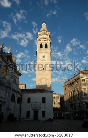 Church tower in the morning sun surrounded by an empty square in Venice, Italy