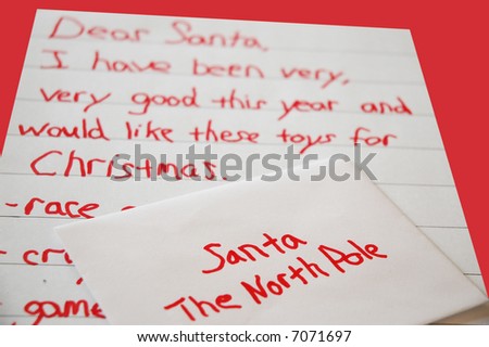 Christmas list written by a child with an envelope addressed to santa at the north pole -on red background