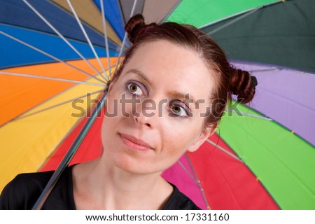 Young woman on the rainbow umbrella background